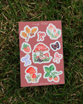 Sticker sheet with nature-themed designs on a grass background