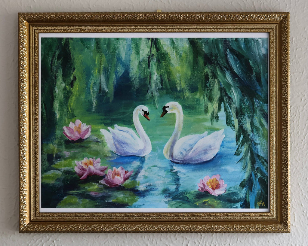 Framed painting of two swans on a pond with flowers and foliage.