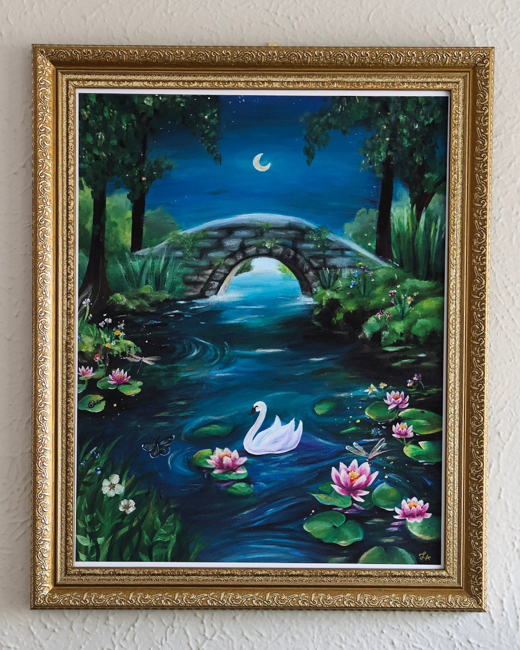 Framed artwork of a serene landscape with a swan, bridge, and moonlit sky.